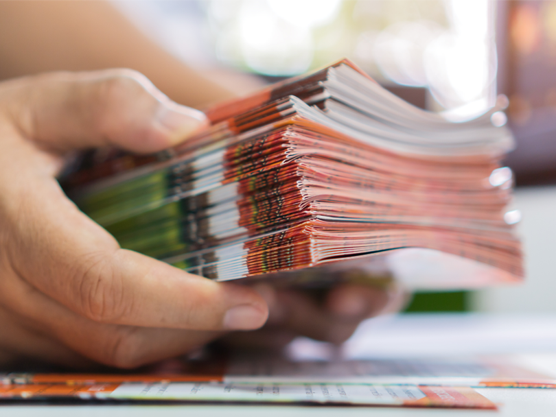 Stack of brochures printed at a commercial printer.